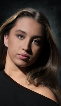 A close-up portrait capturing the allure of a young woman with soft natural lighting.