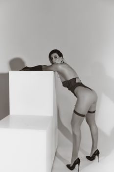 Artistic black and white boudoir shot, emphasizing elegance and fashion.