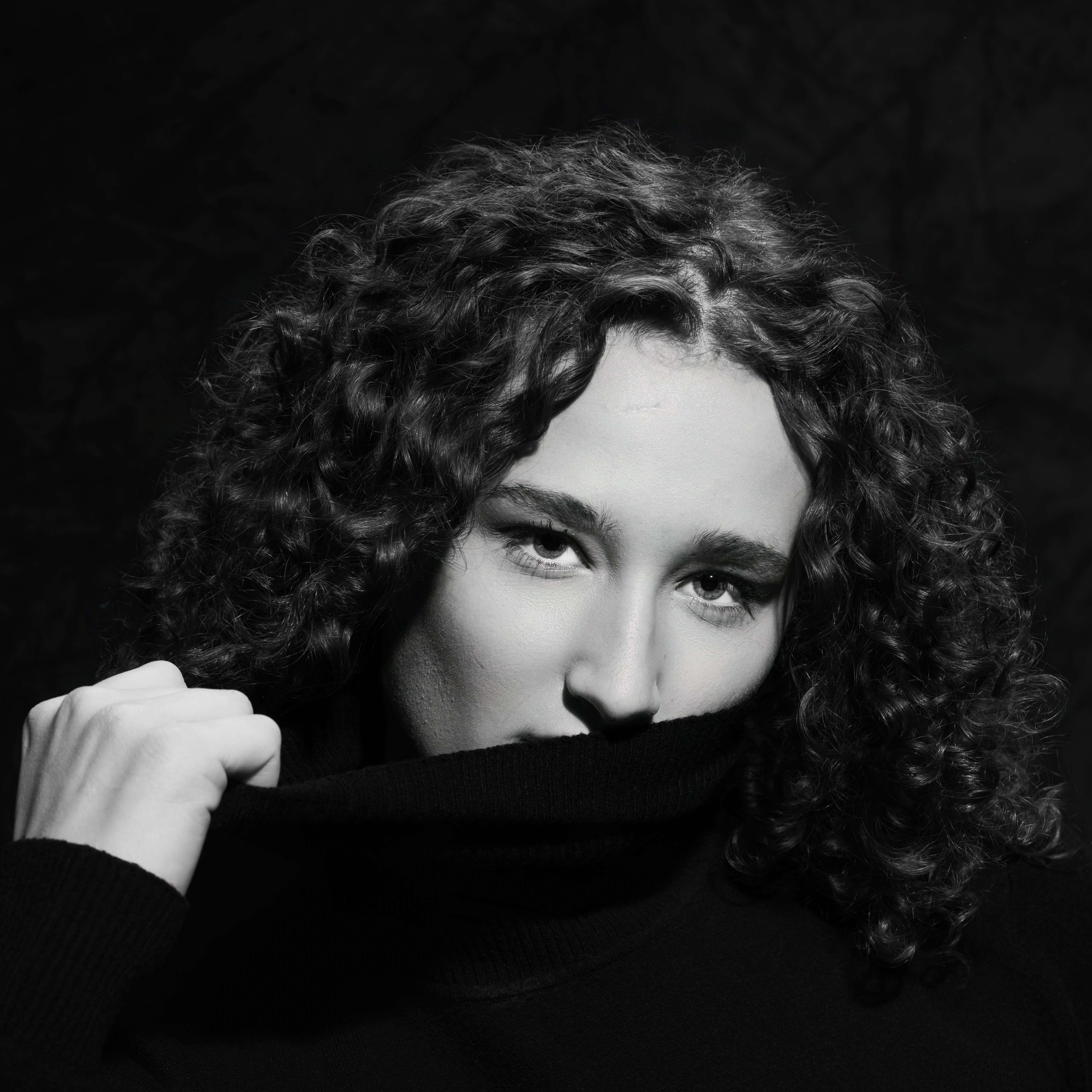 Black and White Portrait of a Woman with Curly Hair · Free Stock Photo