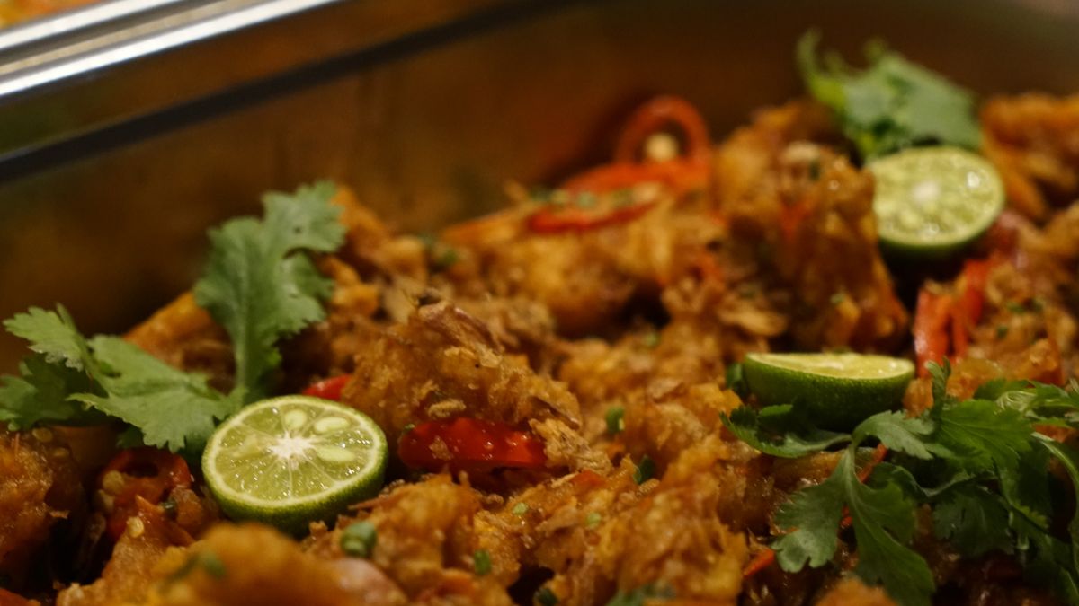 Indian curry with lime and coriander in a steel serving dish (Café Catering in Vellore)