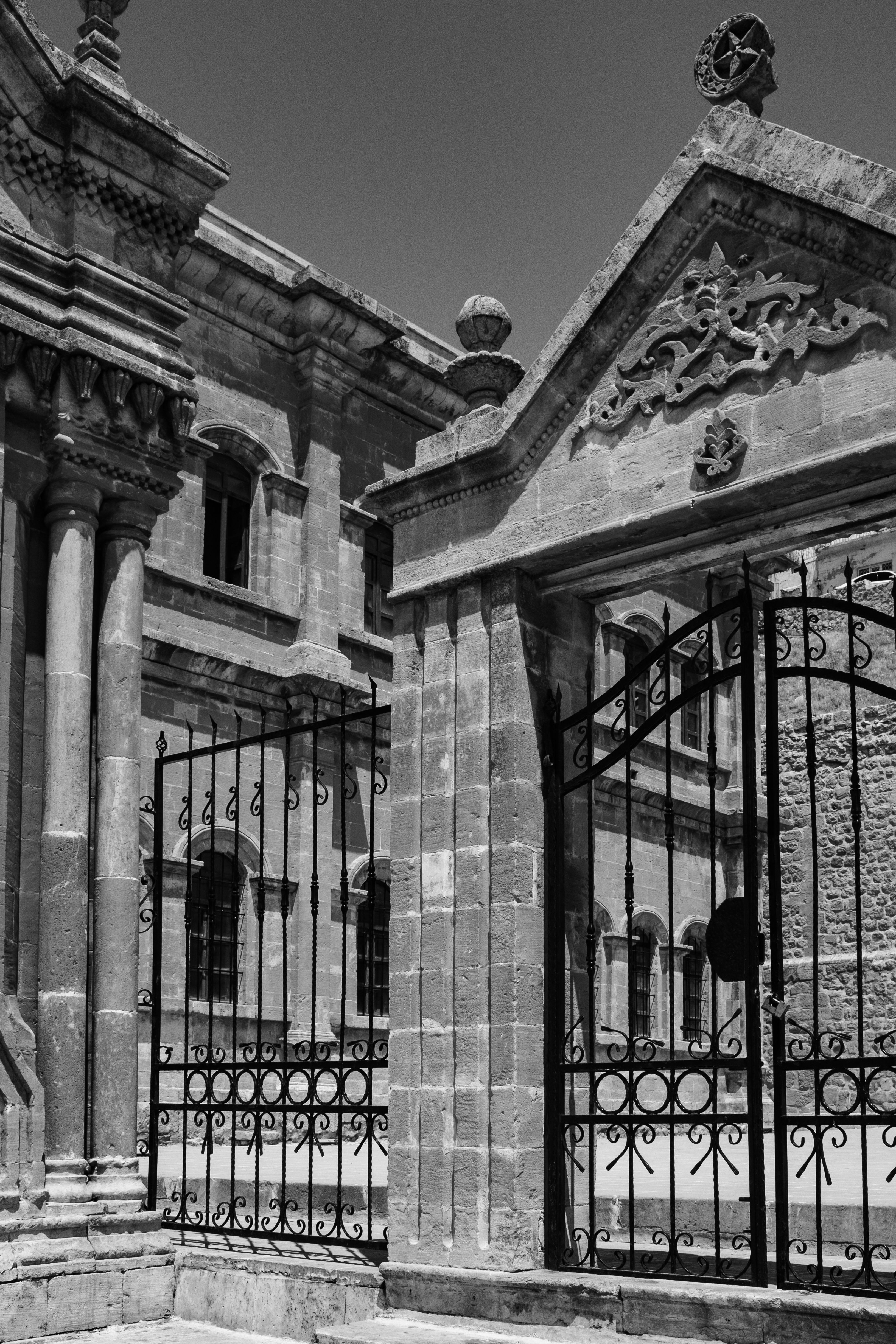 Historic Stone Architecture with Iron Gate · Free Stock Photo