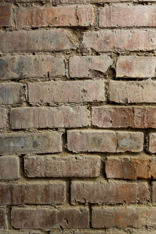 Free Close-up of a rugged red brick wall. Ideal for architectural and texture backgrounds. Stock Photo
