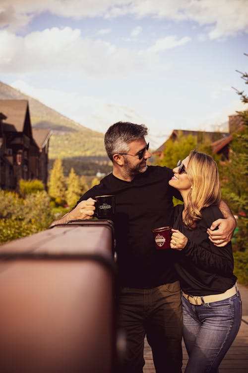 Man Hugging Woman And Having Coffee