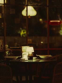 A warm and inviting dinner table setting in a dimly lit restaurant setting.