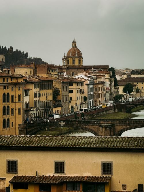 Free Serene view of Florence's historic architecture along the Arno River featuring Santo Spirito. Stock Photo