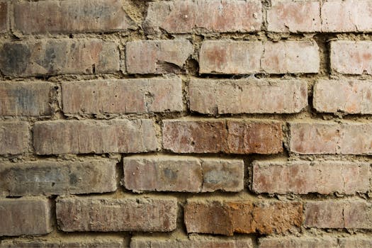 Close-up of a rustic red brick wall with aged texture, perfect for backgrounds.