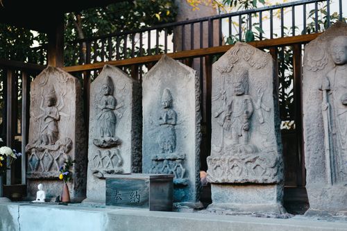 Free Ancient stone steles with detailed carvings in a tranquil Japanese temple setting. Stock Photo