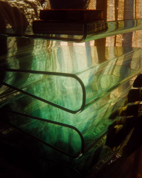 Free Glass shelves reflecting sunlight create mesmerizing abstract patterns indoors. Stock Photo