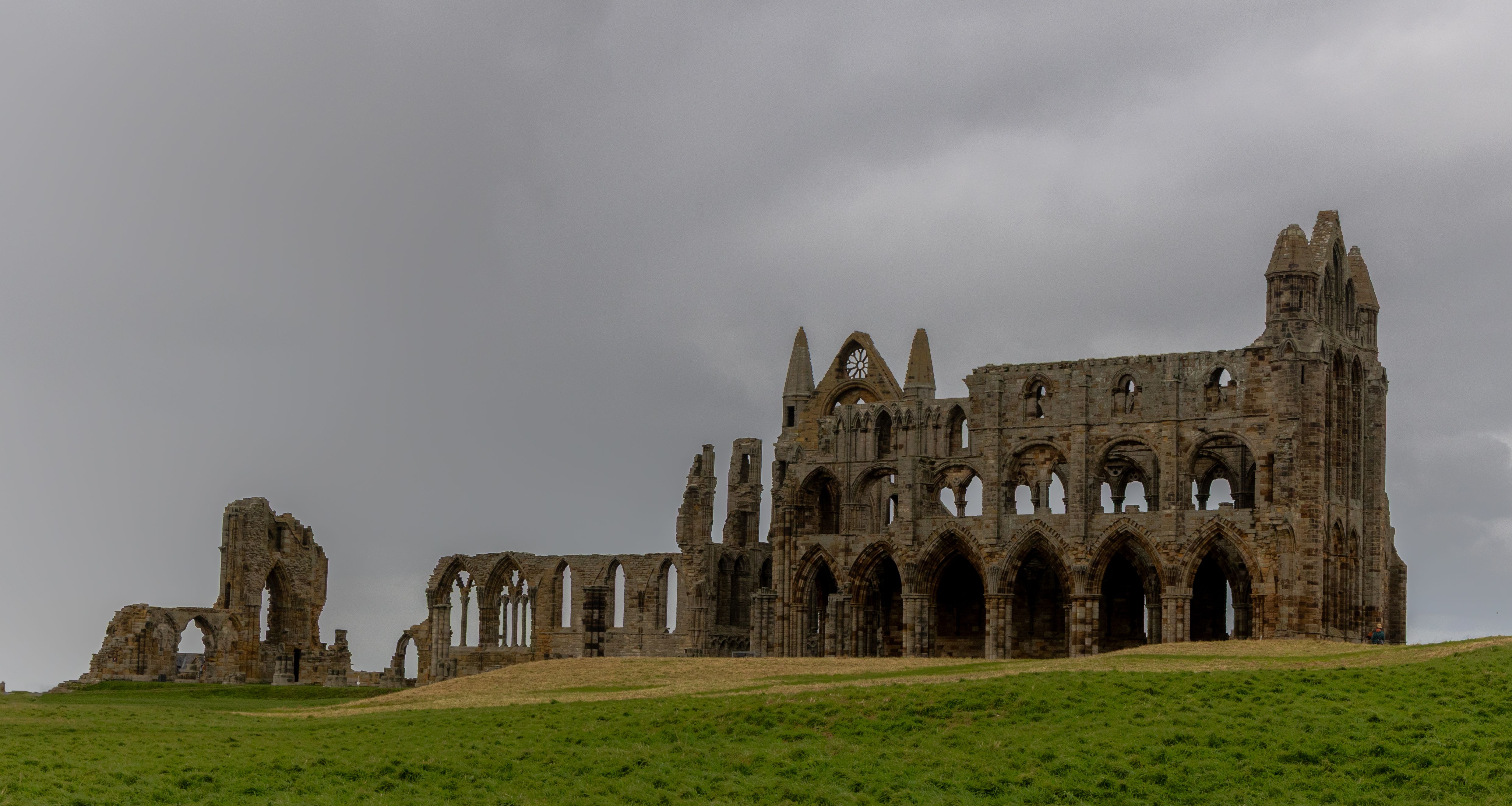 The Gothic ruins of Whitby Abbey, gaunt against a grey North Sea sky.
