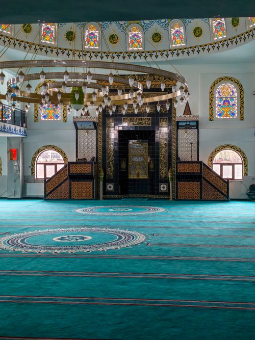 Free Stunning mosque interior with detailed decor and vibrant stained glass windows. Stock Photo