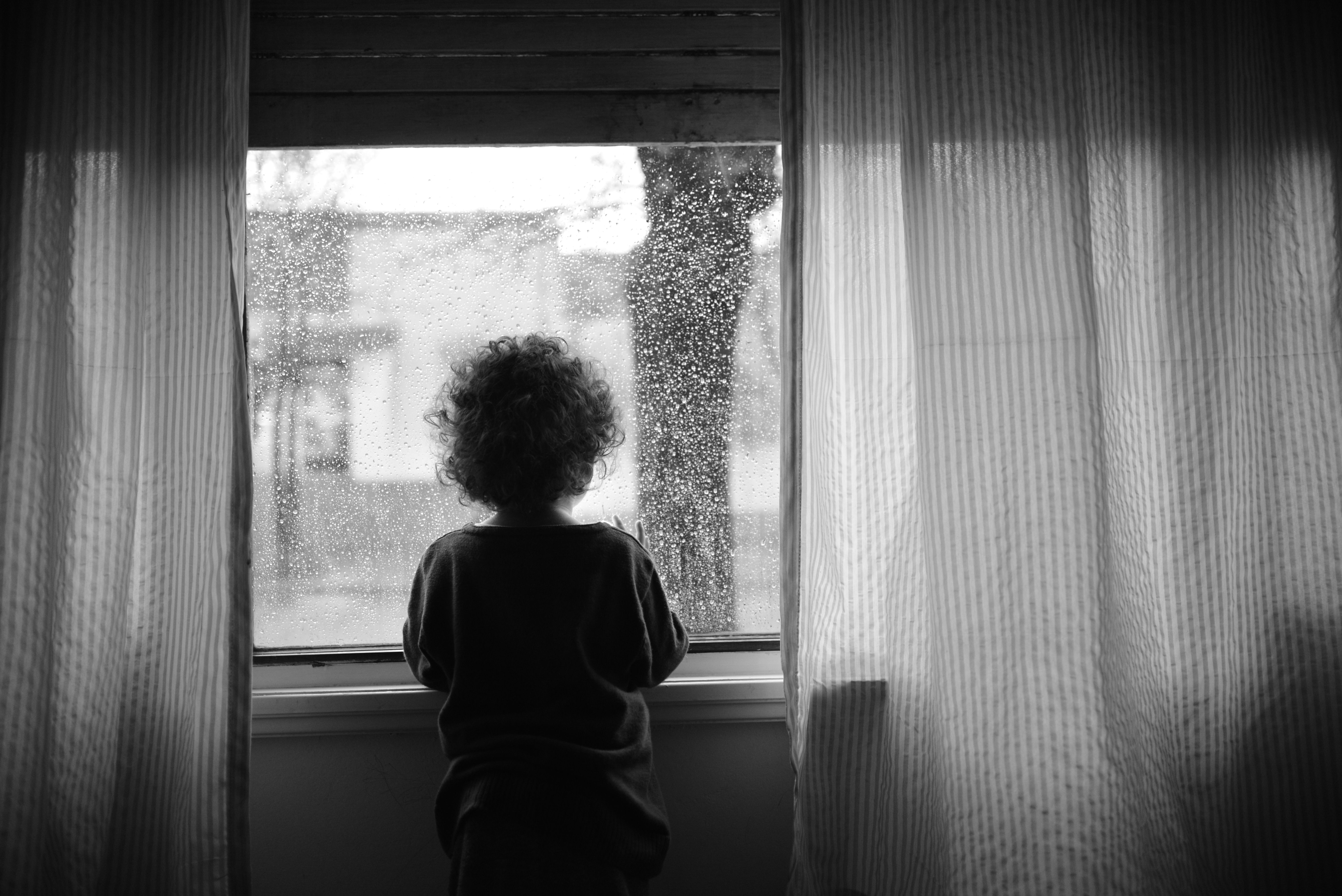 Girl Standing near Window with Raindrops · Free Stock Photo