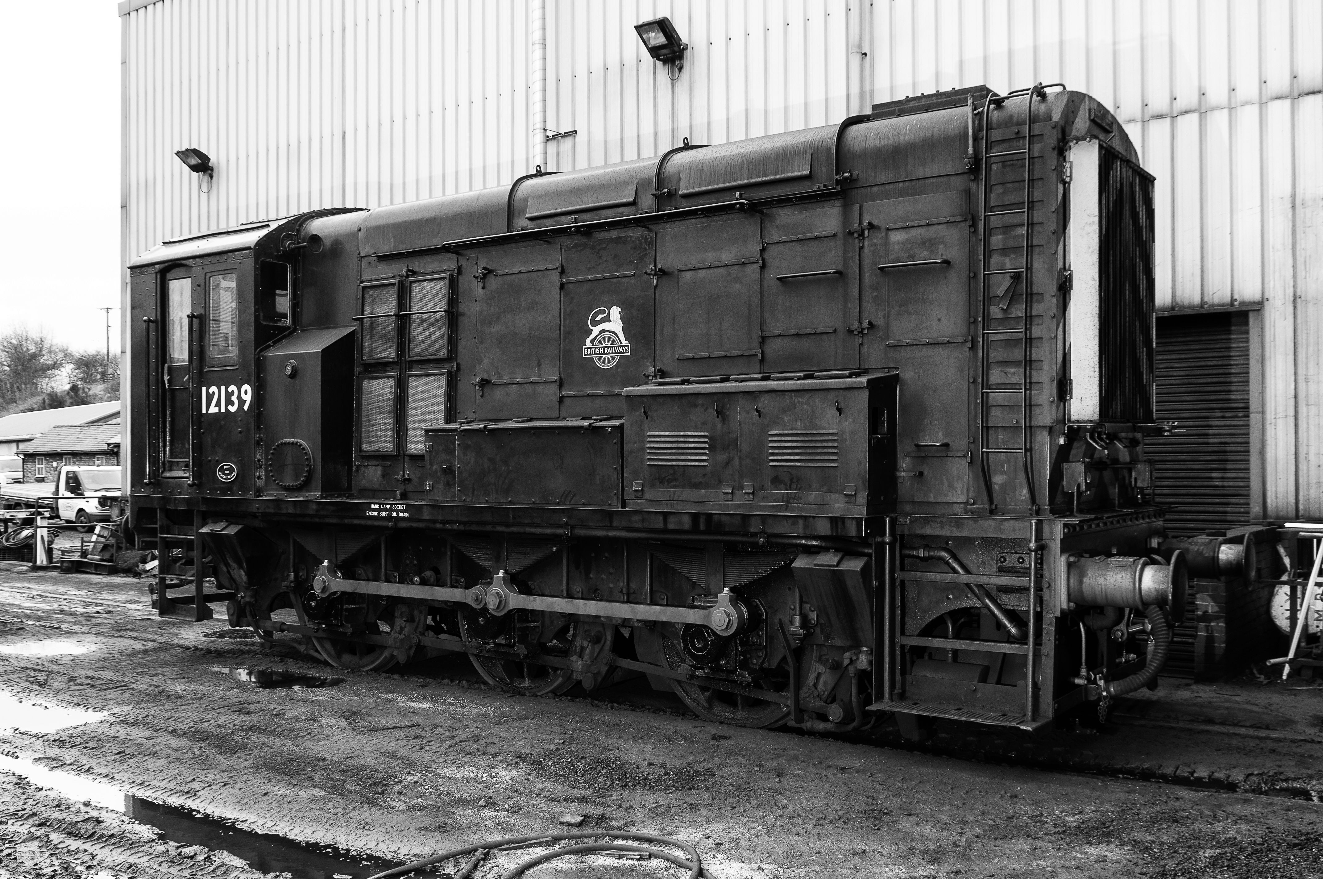 A monochrome image of an old diesel shunter train at a railway yard in Grosmont, North Yorkshire.