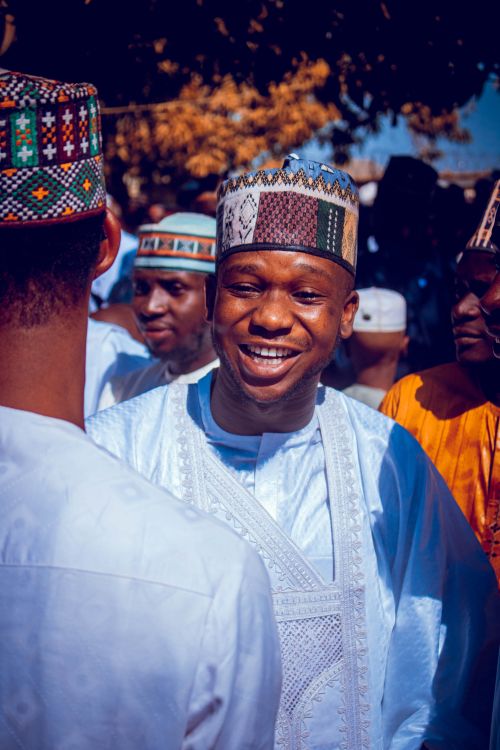 Free A joyful gathering of men in traditional African attire, exchanging smiles and conversation. Stock Photo