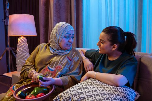 Free Middle Eastern mother and daughter sharing quality time indoors. Stock Photo