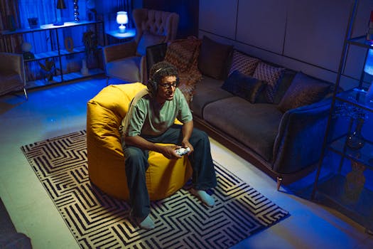 Middle-aged man wearing headphones, gaming in a cozy living room at night.