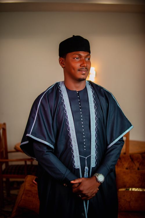 Free Portrait of an adult man wearing traditional African clothing indoors, with a confident expression. Stock Photo