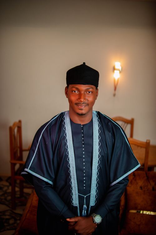 Free Man in elegant traditional African dress with intricate embroidery, indoors. Stock Photo