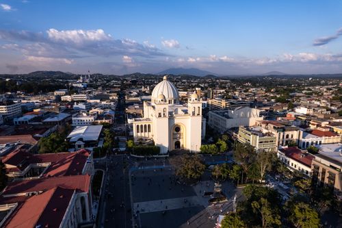 Free Breathtaking aerial view of San Salvador Metropolitan Cathedral surrounded by cityscape during sunset. Stock Photo