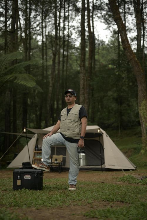 Free Man enjoying a camping trip in the lush forests of West Java, Indonesia. Stock Photo