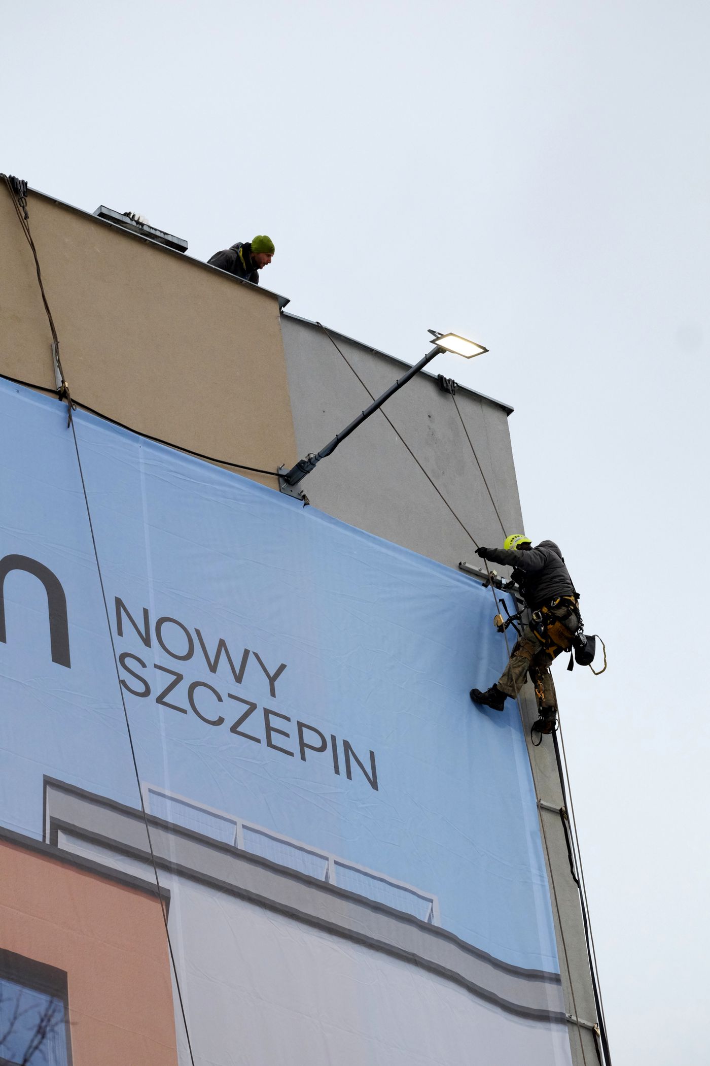 Large printed vinyl banner installed on a building exterior