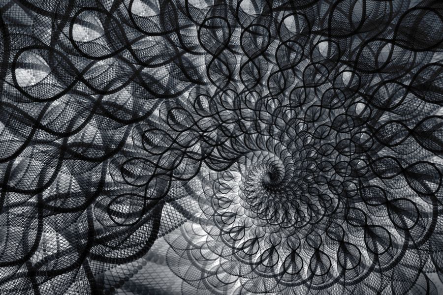 Abstract black and white spiral with geometric and repetitive patterns, perfect for artistic and creative backgrounds.