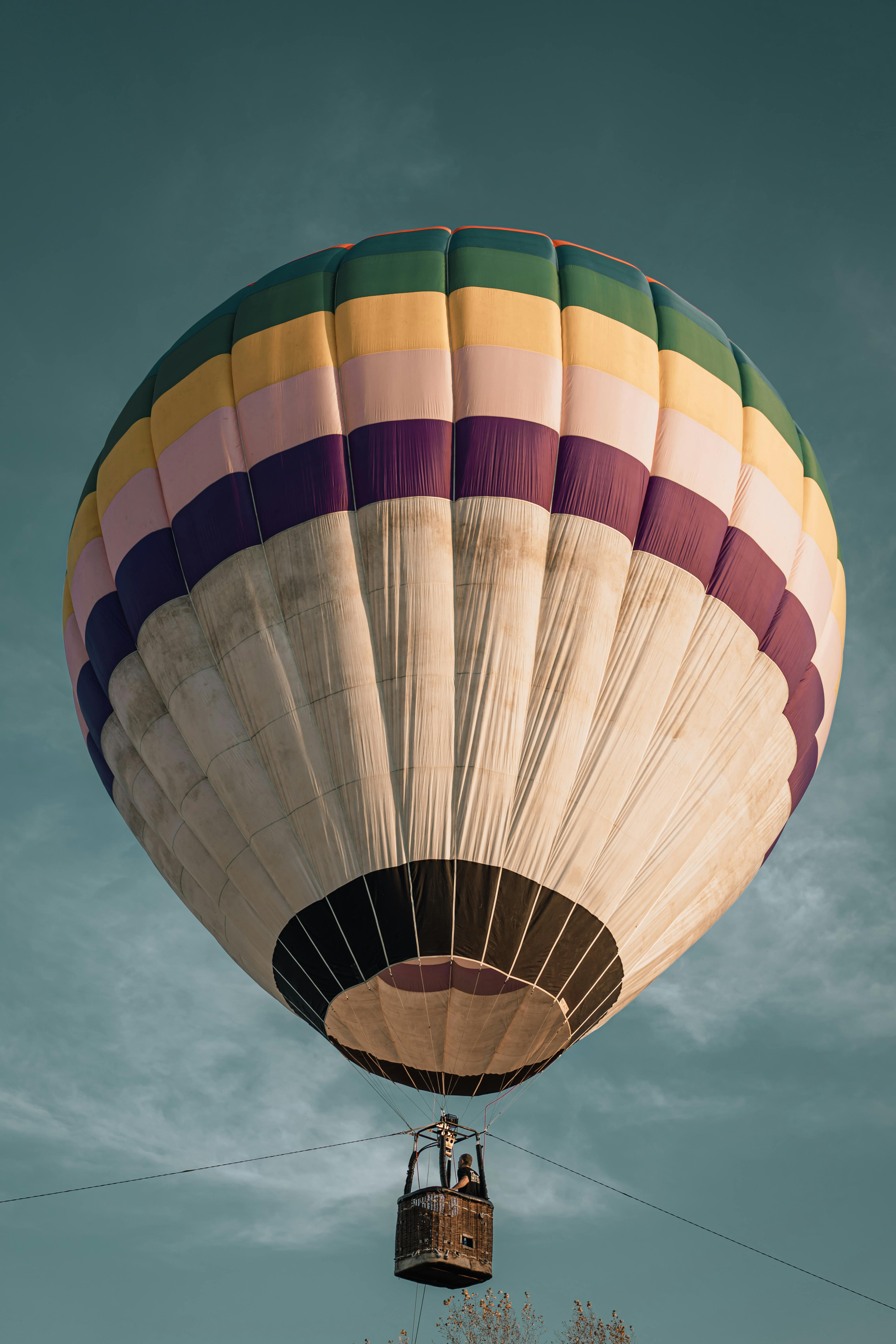 A vibrant hot air balloon floating peacefully in the clear sky.