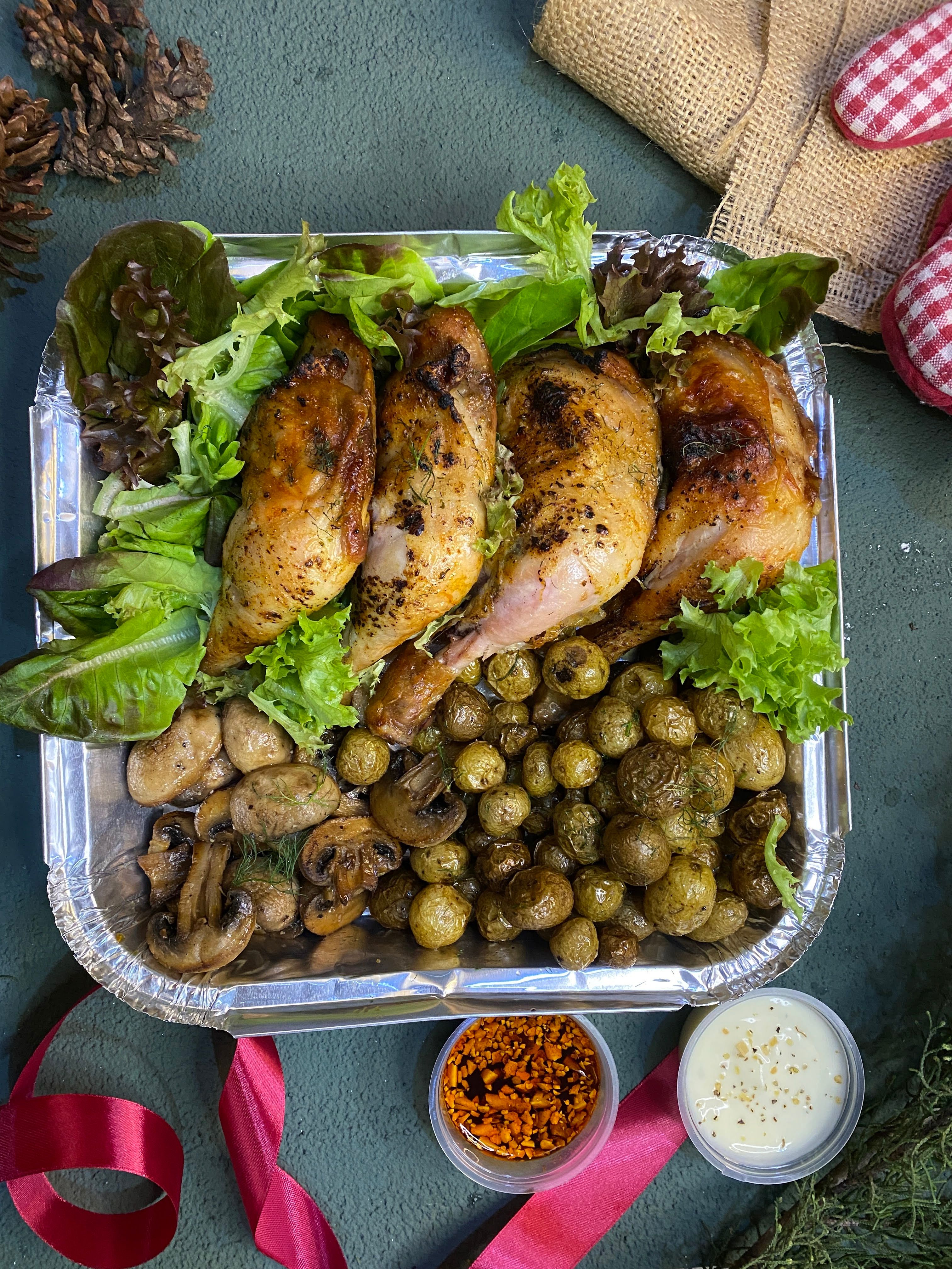 Delicious grilled chicken with mushrooms and potatoes, served with fresh lettuce.