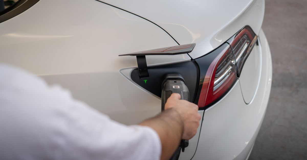 Close-up of an electric car charging cable and port