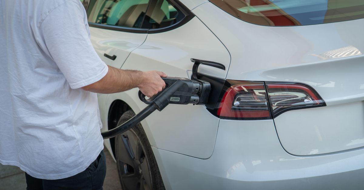 Electric car being charged at a station, highlighting eco-friendly transportation.