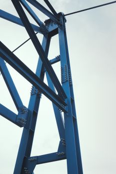 Abstract view of a blue steel structure reaching into the sky, showcasing geometry and architecture.