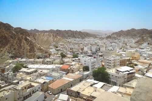 Free A stunning aerial view of Muscat, Oman, showcasing its unique architecture nestled between rugged mountains. Stock Photo
