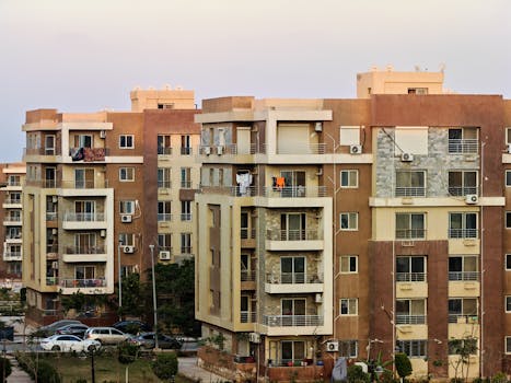 Urban residential buildings with balconies and air conditioning units.