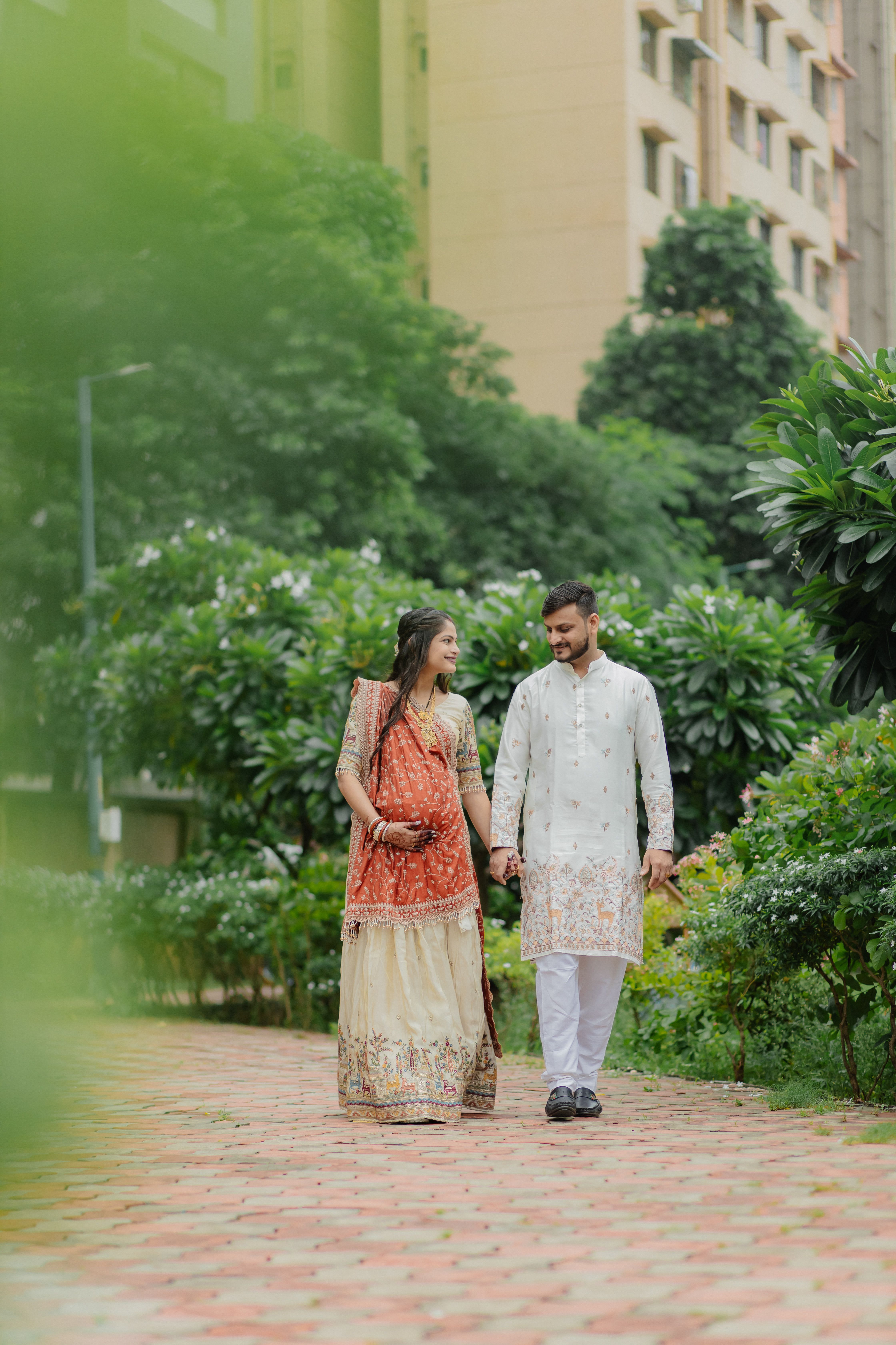 Couple Strolling in Traditional Attire Outdoors · Free Stock Photo