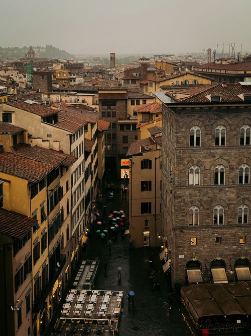 Free A picturesque evening scene in Florence, Italy featuring historic architecture and lively streets. Stock Photo
