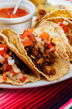 Delicious tacos with seasoned meat, onions, and salsa served in Cuenca, Ecuador.