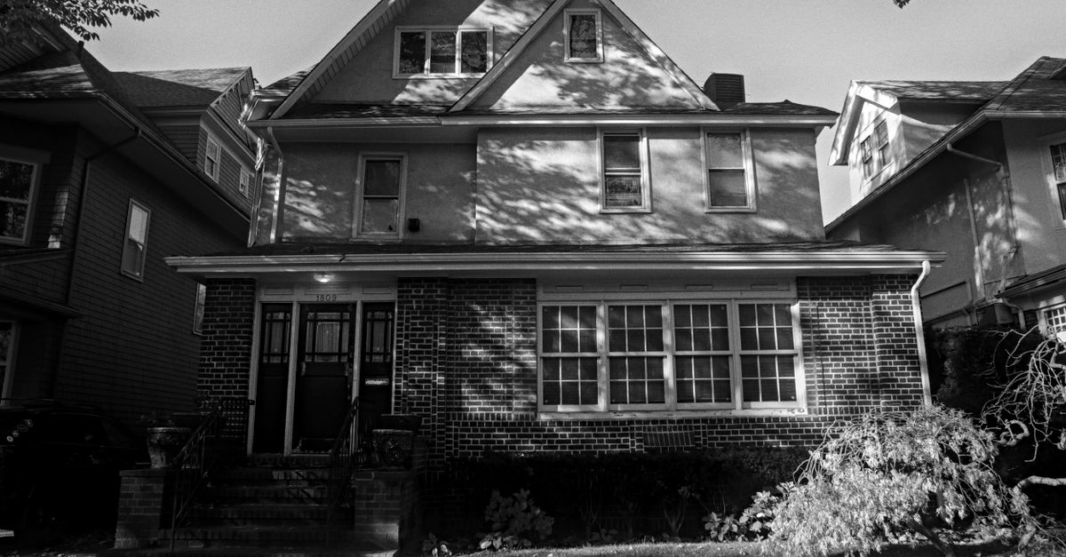 Timeless black and white photo of a suburban New York house with classic architectural details.