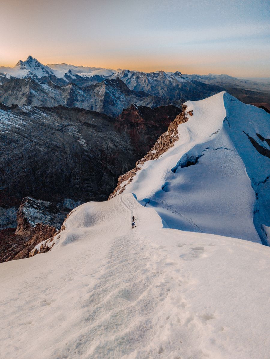 Lone climber on a snow ridge at dawn — photo by Giancarlo Principe on Pexels
