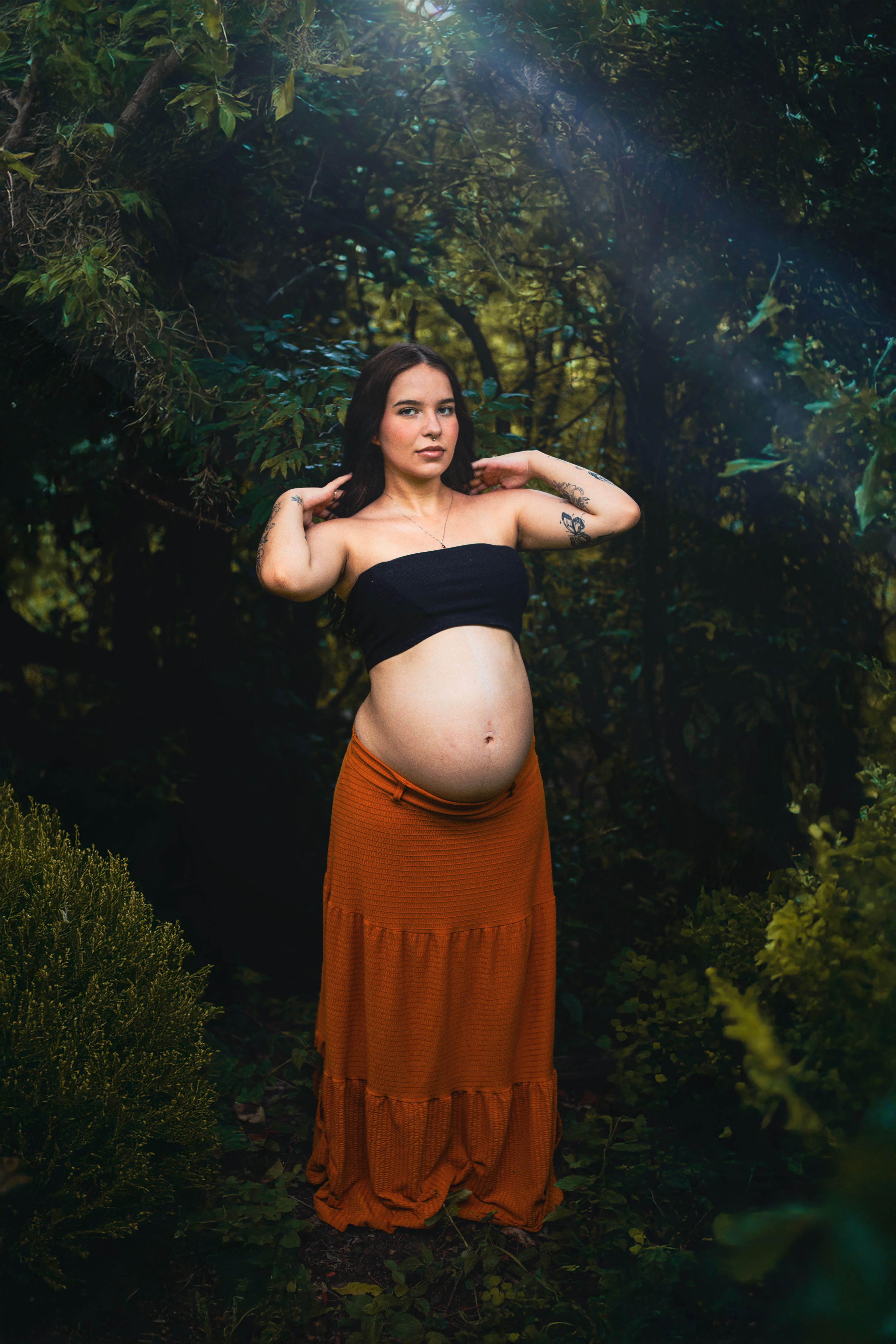 Pregnant Woman Posing in Lush Forest Setting · Free Stock Photo