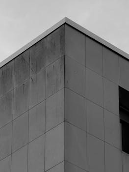 Black and white photo of a sleek modern building corner with clean lines.
