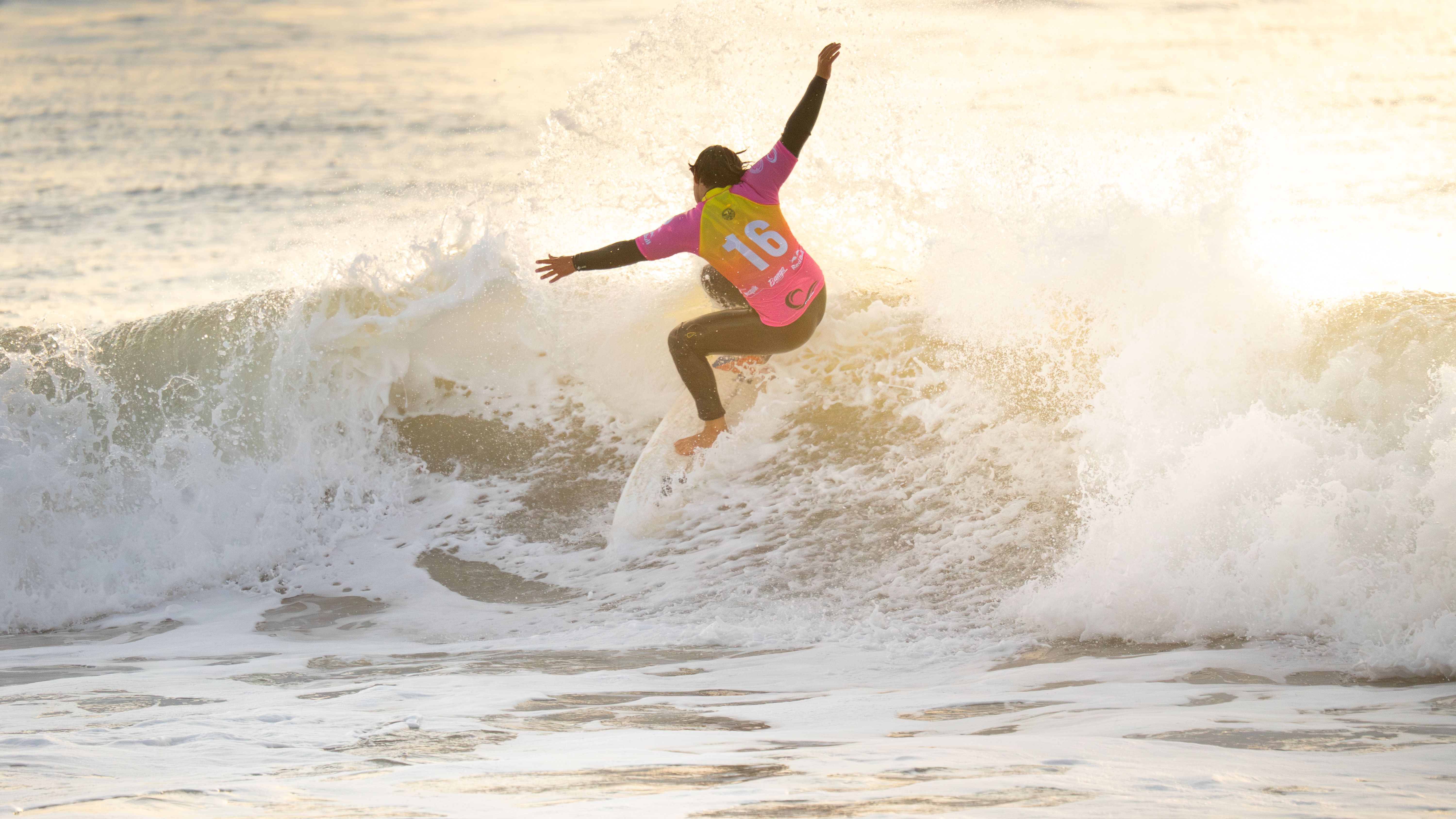 Surfer catches a wave at sunset with vibrant colors and dynamic motion. Ideal for adventure and sports themes.