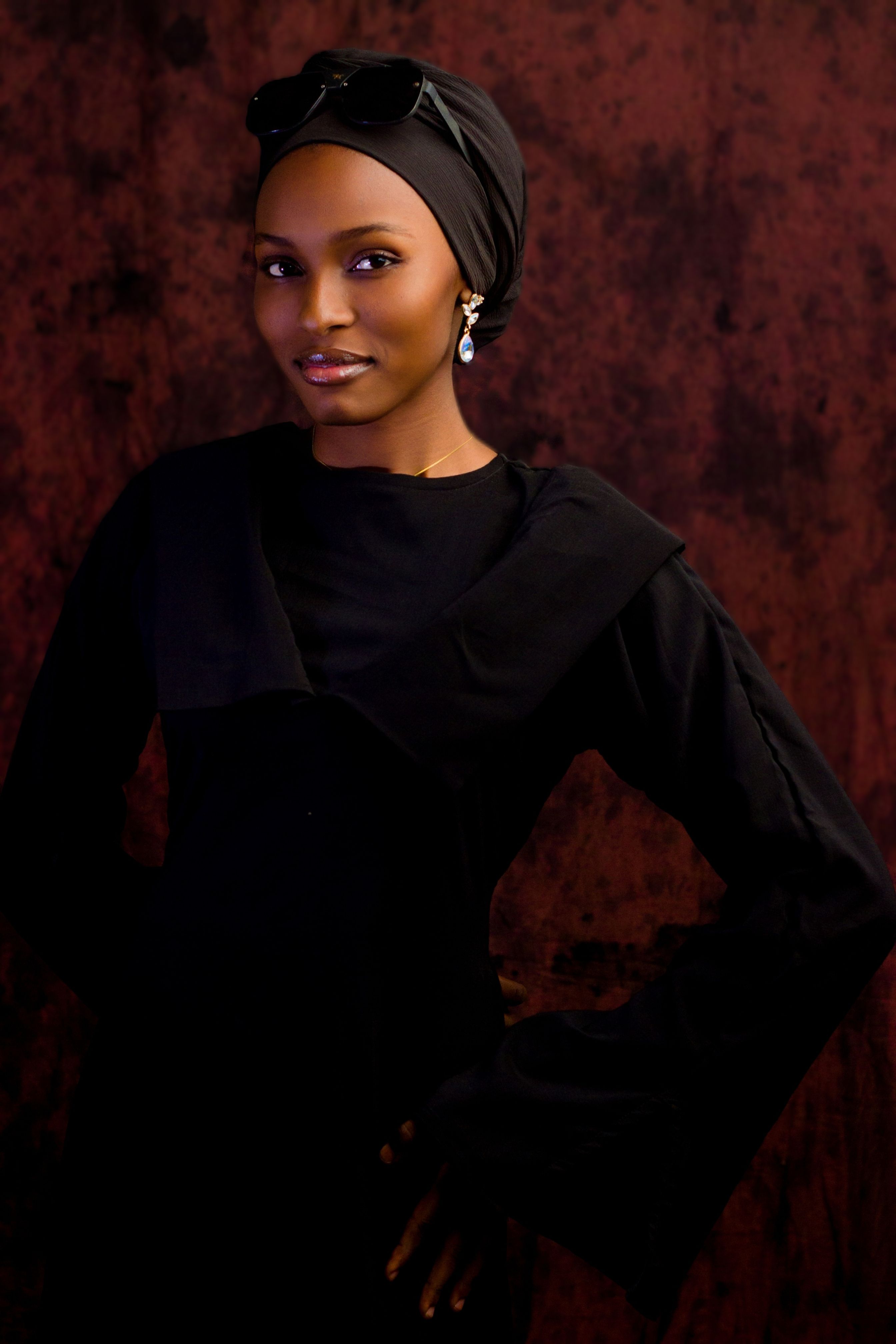 Portrait of a sophisticated woman in a dark, elegant outfit, exuding grace and style.