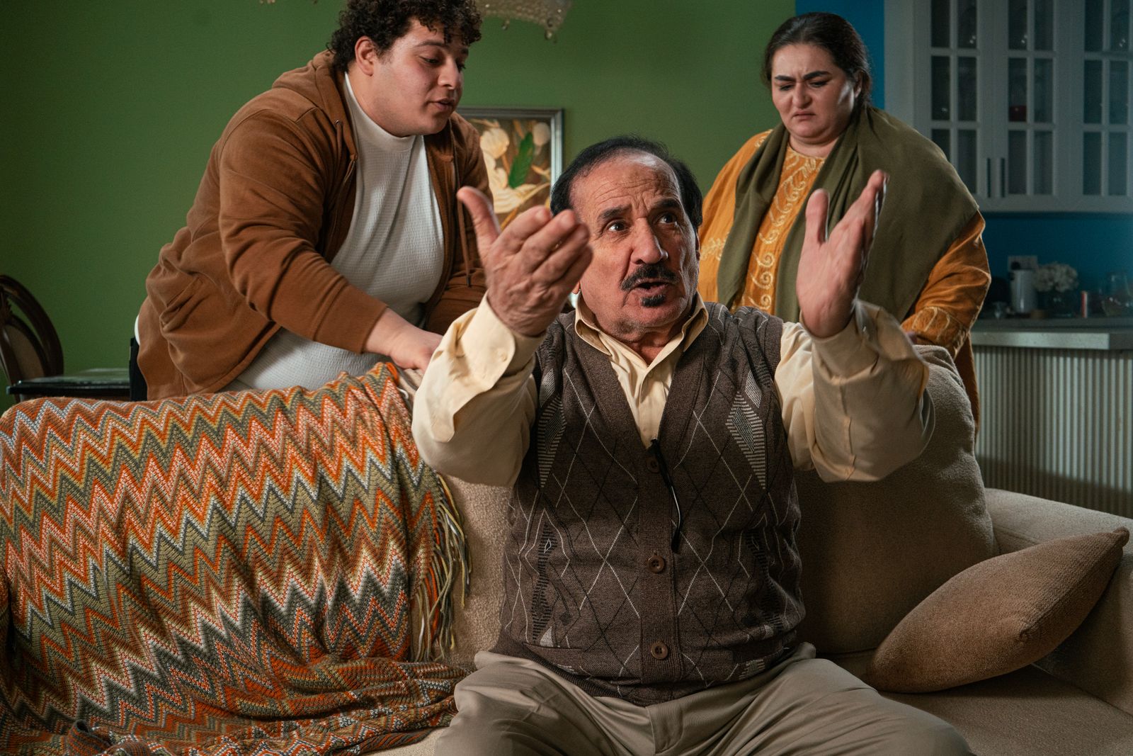 Older adult speaking with family members during an important multigenerational conversation