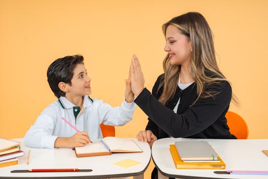 A teacher and student exchange a high-five in a classroom, fostering a positive learning environment.