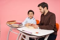 Father Helping Son with Homework at Desk
