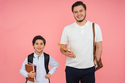 Portrait of a smiling teacher and student holding books against a bright pink background.