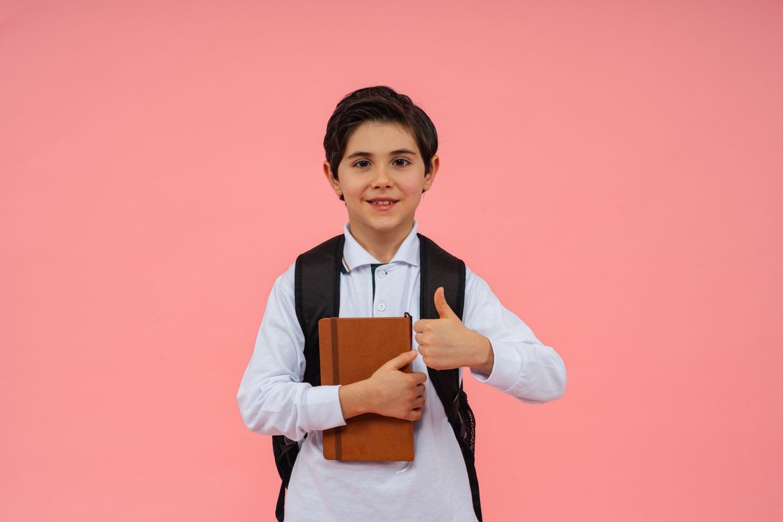 Happy Schoolboy with Book and Backpack · Free Stock Photo