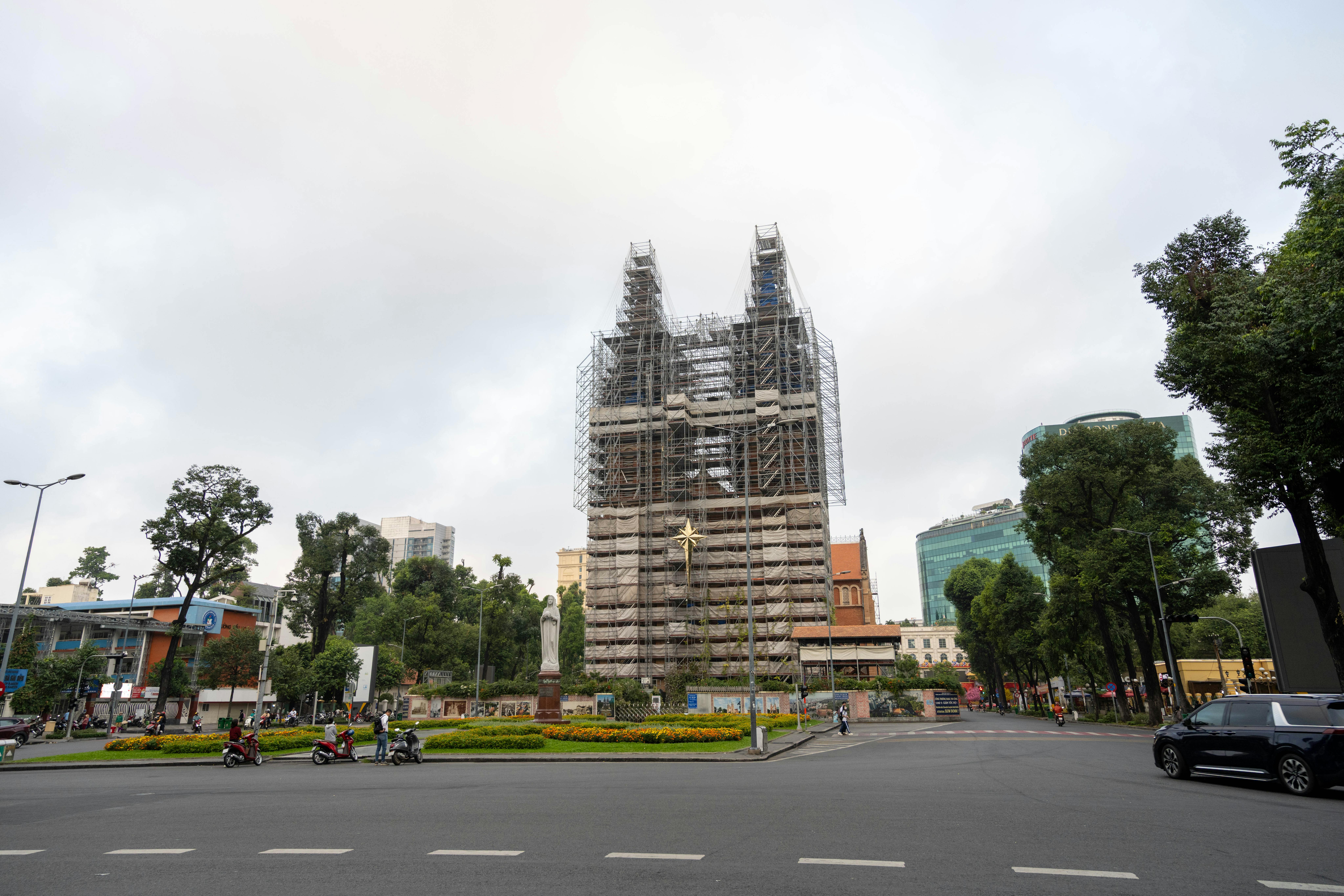 Notre-Dame Cathedral Basilica in Ho Chi Minh City surrounded by scaffolding during renovation.