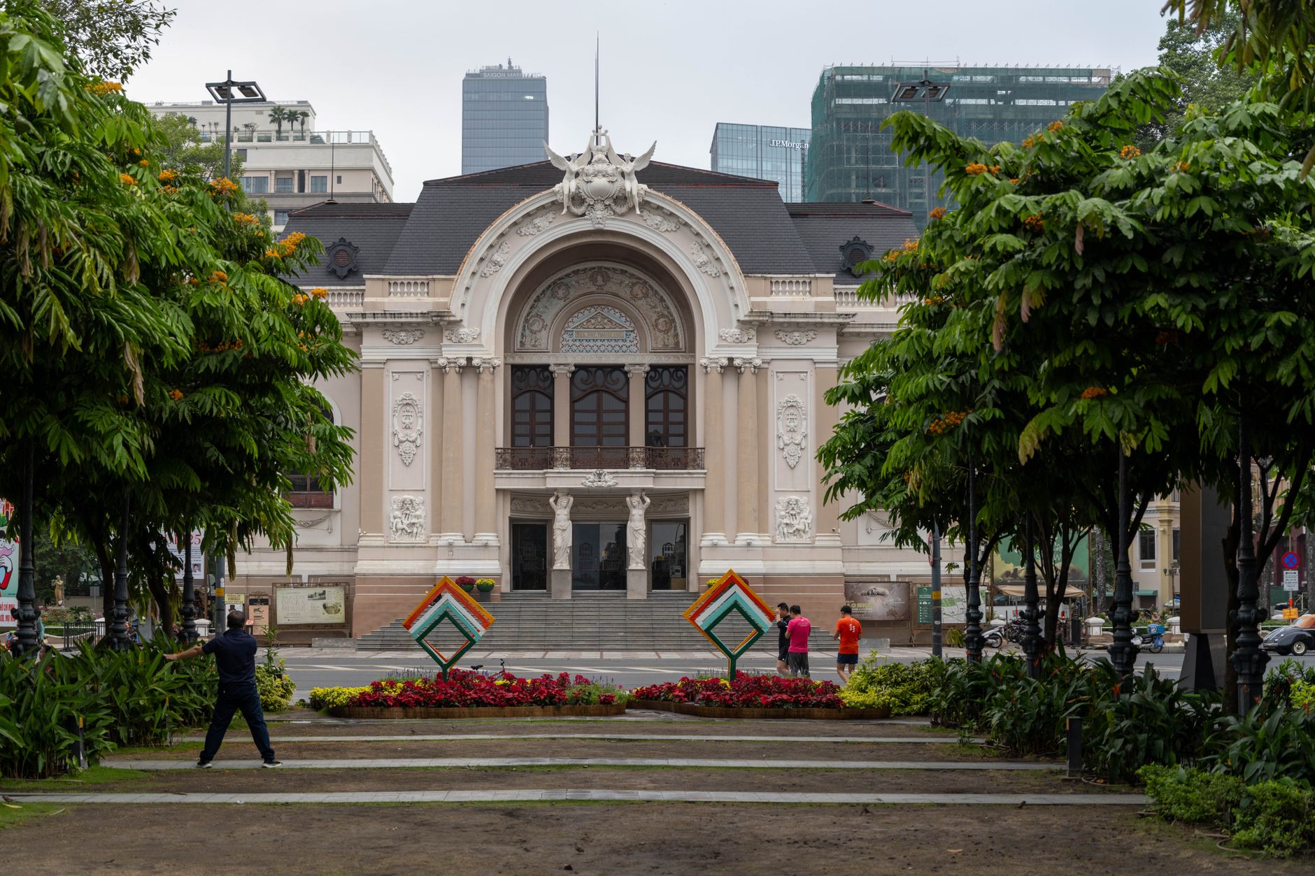 Stunning view of Saigon Opera House facade in Ho Chi Minh City, Vietnam, surrounded by vibrant greenery.