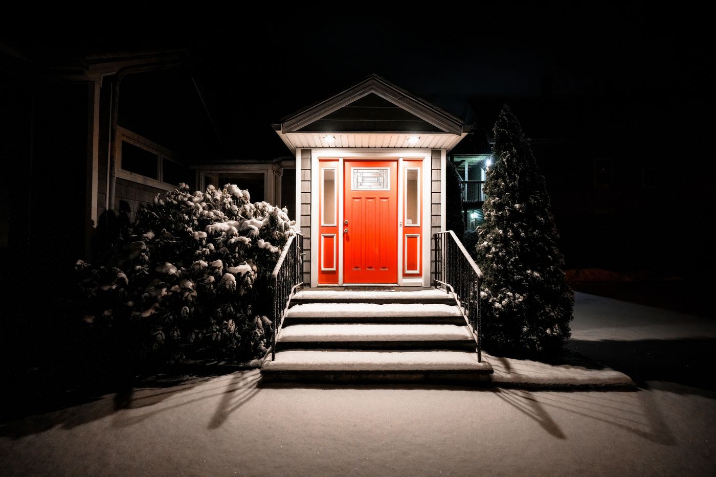 Lit front door of a home at night