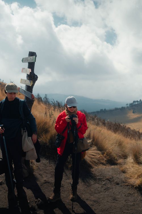 Free Two hikers explore a breathtaking mountain trail under a cloudy sky. Stock Photo